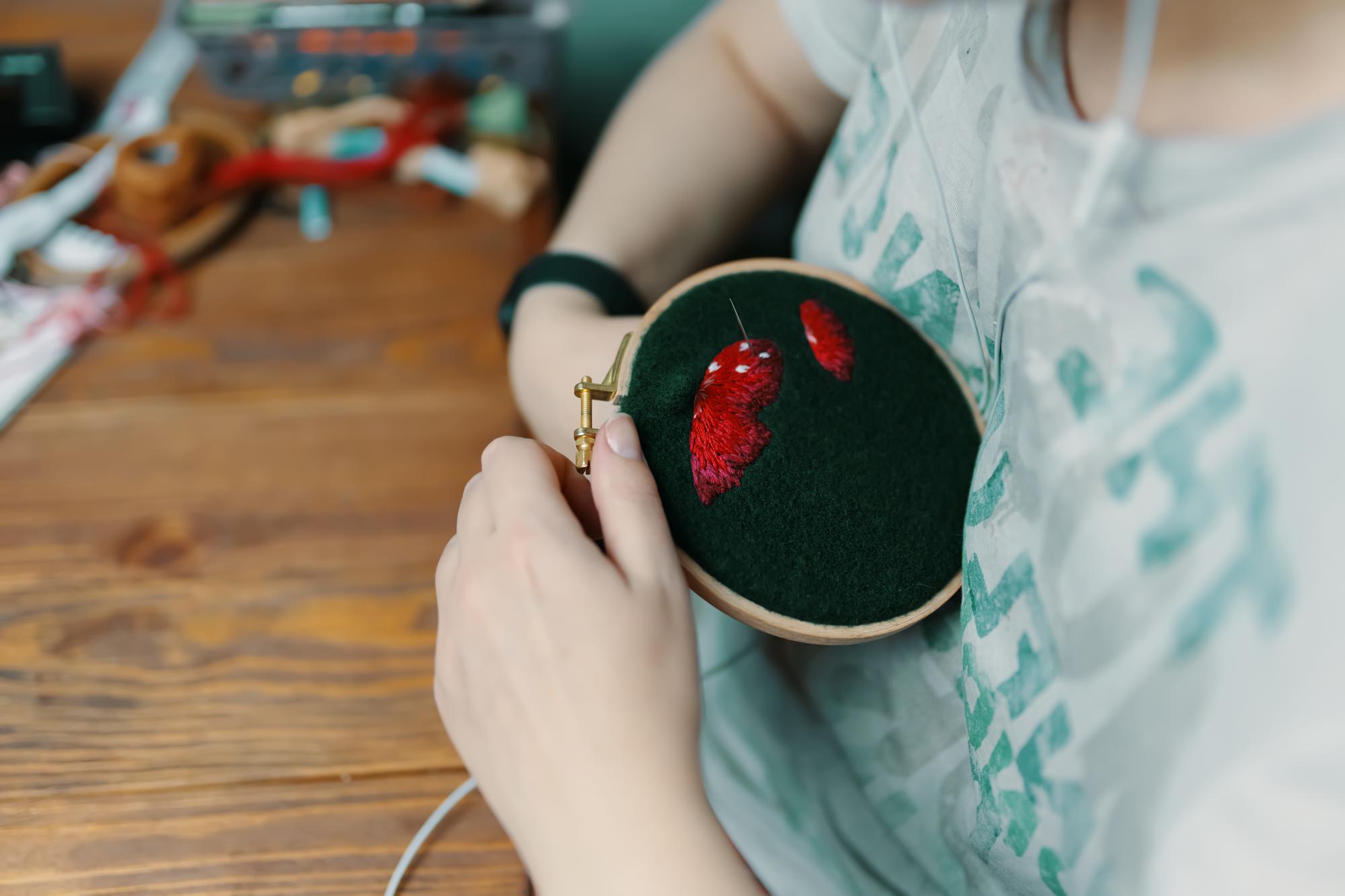 Artisan hands adjusting embroidery hoop