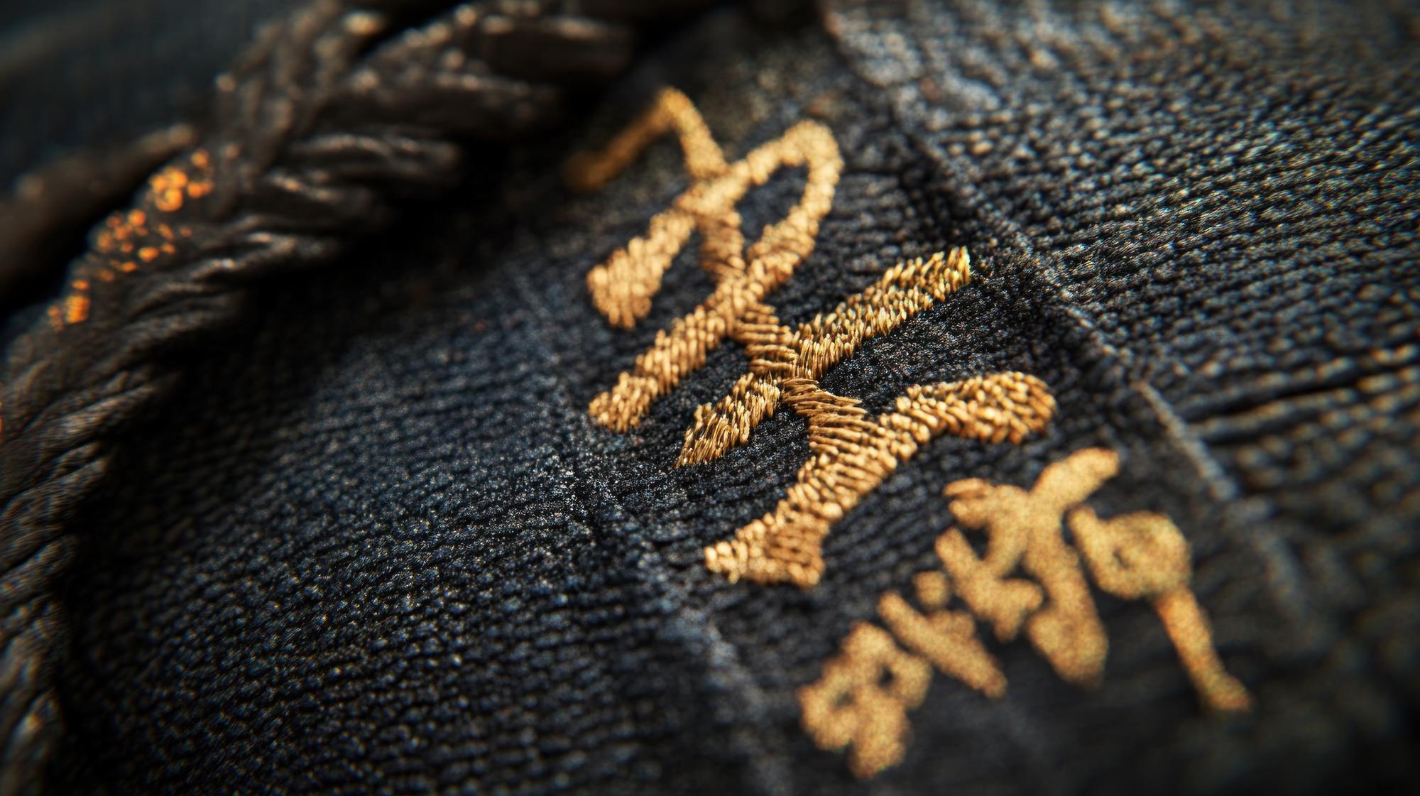 Hand embroidered gold thread on dark linen